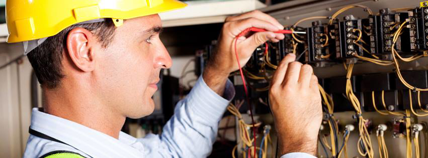 An electrician testing an electrical panel with a multimeter for T-Volt, Inc. Electrical Contractor in Fort Lauderdale, FL.