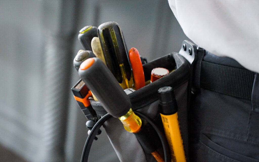 A close-up view of an electrician's tool belt, ready for service from Mister Sparky NWA in Springdale, AR.