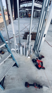 Electrician tools next to electrical conduit rough-in on a concrete floor by Coast Electric Inc in Kenner, LA