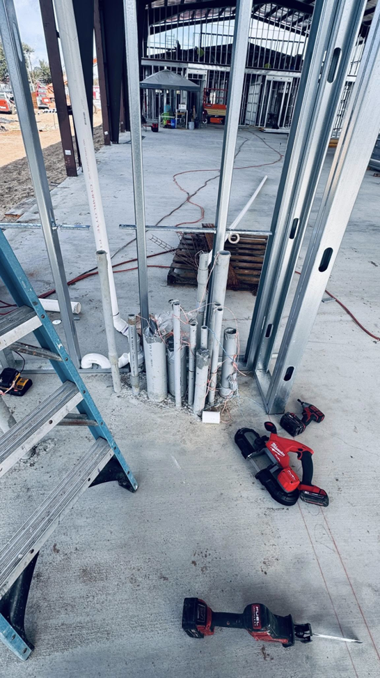 Electrician tools next to electrical conduit rough-in on a concrete floor by Coast Electric Inc in Kenner, LA