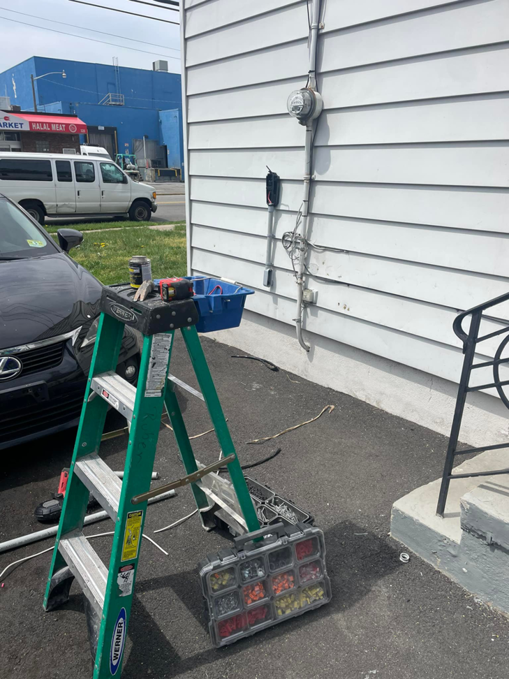 Electrician tools and a ladder set up for electrical work on the side of a house by Ruben's Electric in Harlingen, TX