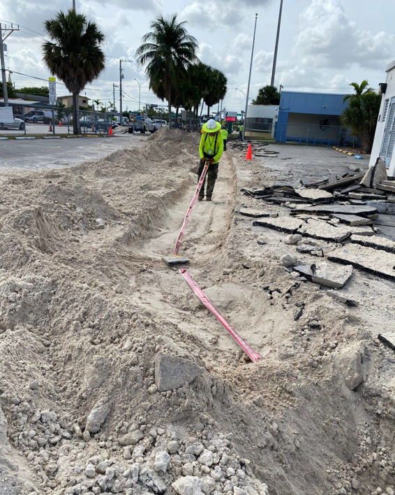 An electrician trenching for underground wiring installation by Canseco Electrical Contractors, Inc. in Miami, FL.