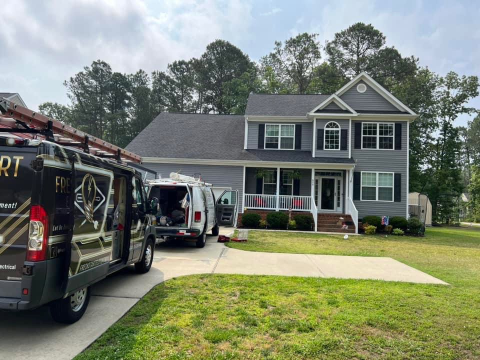 Fresh Start Electrical, LLC vans parked at a residential job site in Newport News, VA