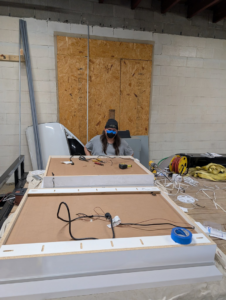 An electrician wiring custom lighting fixtures for Bright Electric in Evansville, IN.