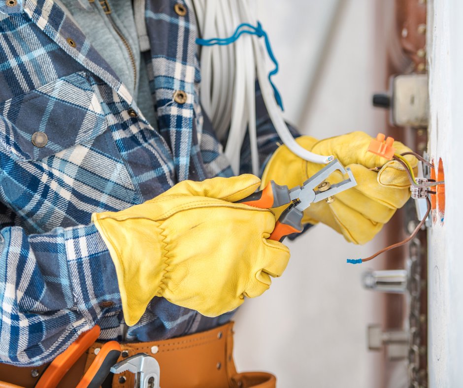 An electrician using wire strippers during an electrical wiring installation by Black Bear Electric in Aurora, CO.