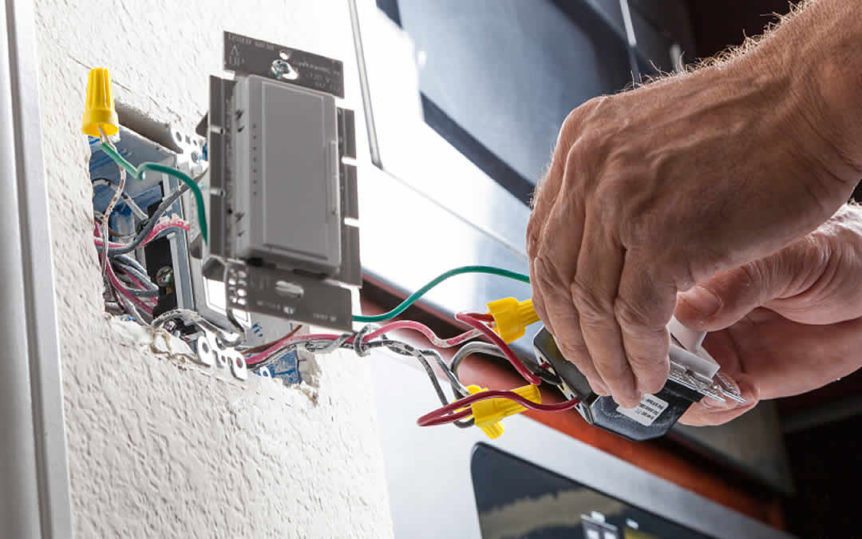An electrician wiring a light switch or dimmer with exposed wires for Star Light Electric LLC in Phoenix, AZ