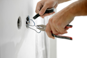 An electrician's hands wiring an electrical outlet for Crawford Electric Co. LLC in West Columbia, SC.