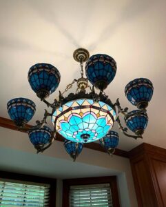 An electrician from High Electrical working on wiring near a water heater in Atlanta, GA.