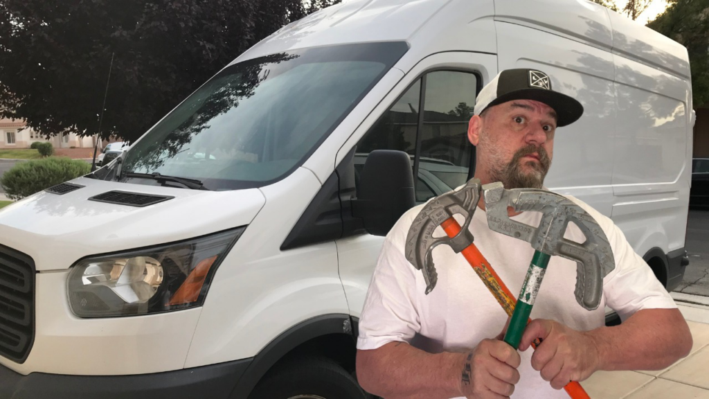 An electrician holding conduit benders in front of a work van for The Las Vegas Electrician in Las Vegas, NV