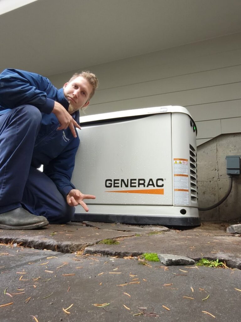 An electrician from Mr. Electric of Rogers posing next to a Generac whole-home generator in Rogers, AR.