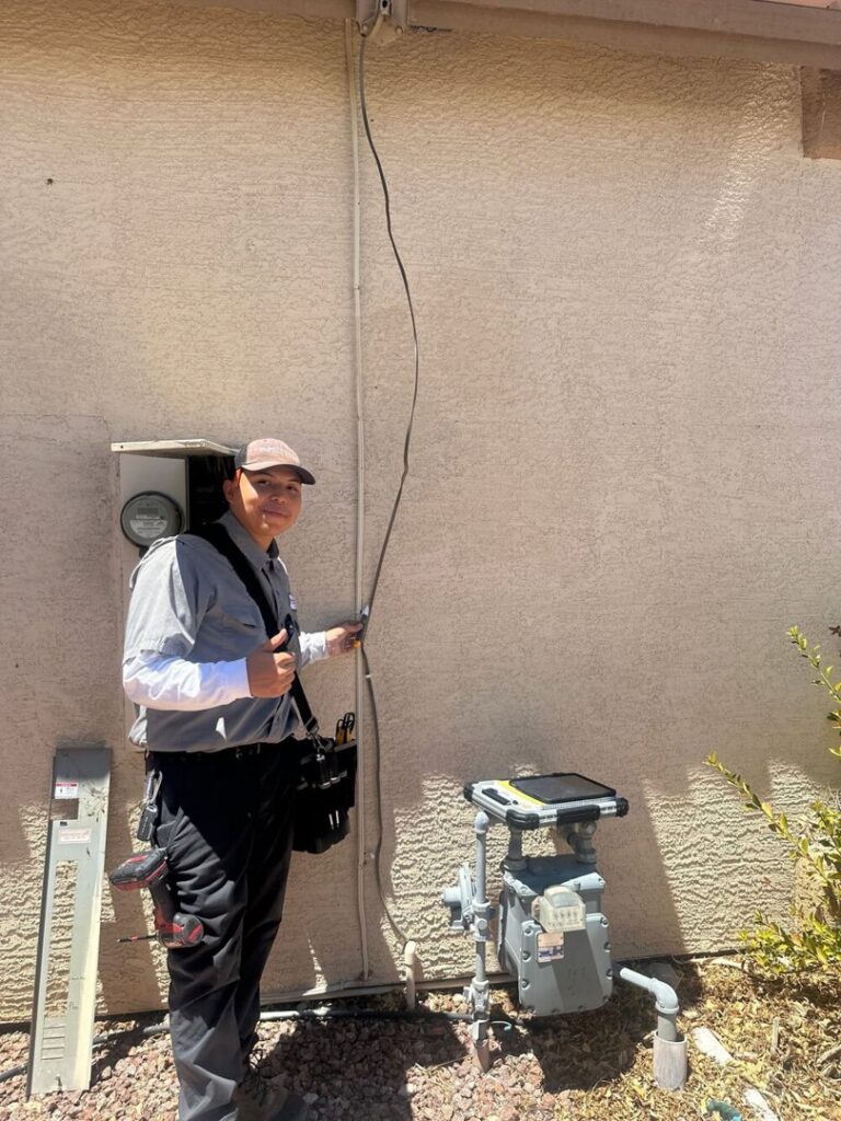 An Electricode electrician giving a thumbs up after completing exterior electrical wiring work in Las Vegas, NV.