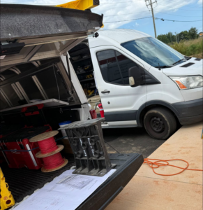 An electrician's work van with tools, spools of wire, and blueprints, ready for a job by C.A Electrical & More in Greenville, SC.