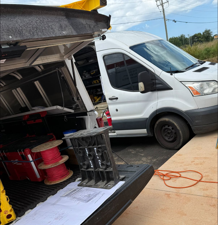 An electrician's work van with tools, spools of wire, and blueprints, ready for a job by C.A Electrical & More in Greenville, SC.