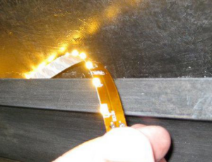 An electrician working with LED strip lights during an installation by Electric Avenue in Lincoln, NE.