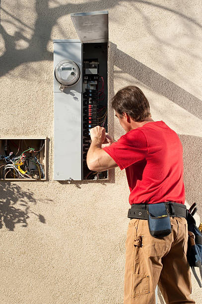 An electrician working on an outdoor electrical breaker panel for Crawford Electric Co. LLC in West Columbia, SC.