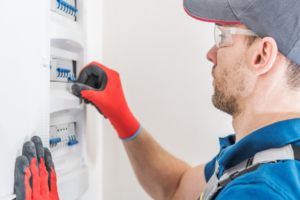 An electrician from EMS Electric of Monroe LLC working on a circuit breaker panel in Monroe, LA.