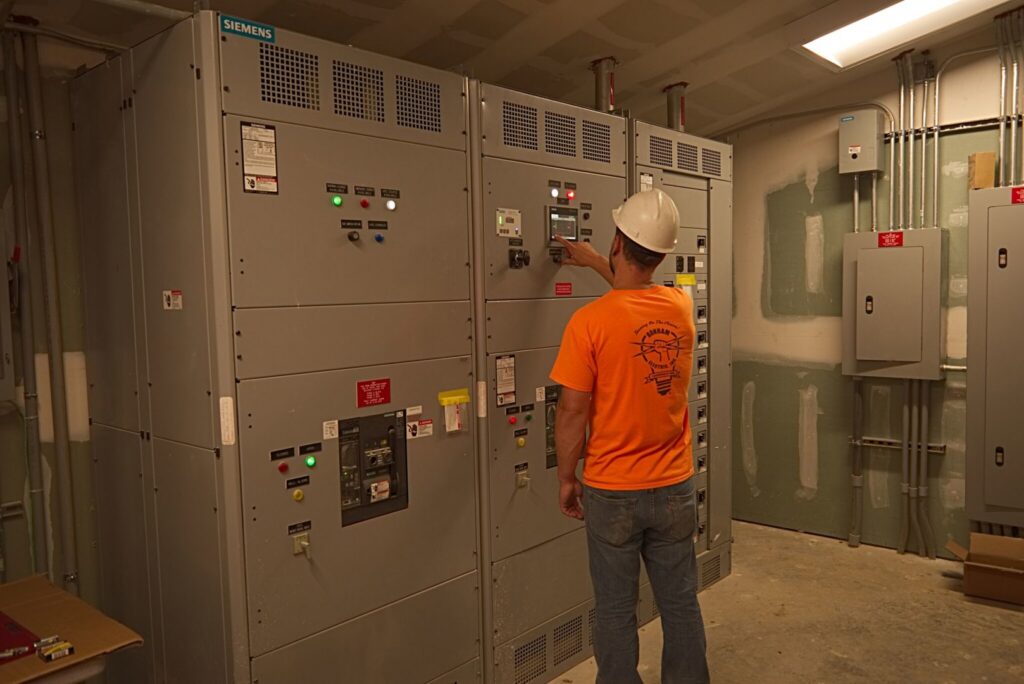 An electrician from Bonham Electric, Inc. working on commercial switchgear in Sacramento, CA.