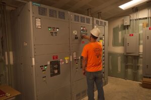 An electrician from Bonham Electric, Inc. working on commercial switchgear in Sacramento, CA.