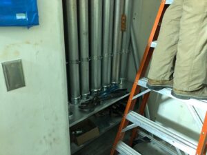 An electrician working on conduit installation, with tools visible, for RD Graham Electric, LLC in Greensboro, NC.