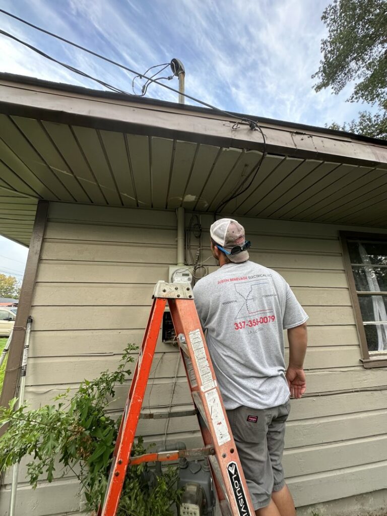 An electrician working on an external electrical meter and service entrance for Justin Benevage Electrical, LLC in Lake Charles, LA
