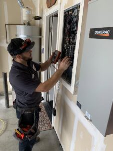 An electrician from AAA Electrical Services working on an open electrical panel with a multimeter, next to a Generac generator in Sacramento, CA.