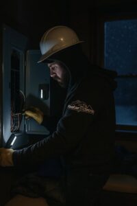 An electrician from Master Controls working on an electrical panel in Cheyenne, WY