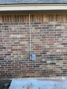 An electrician from Top notch electric llc working on an open electrical panel in Clearwater, FL.