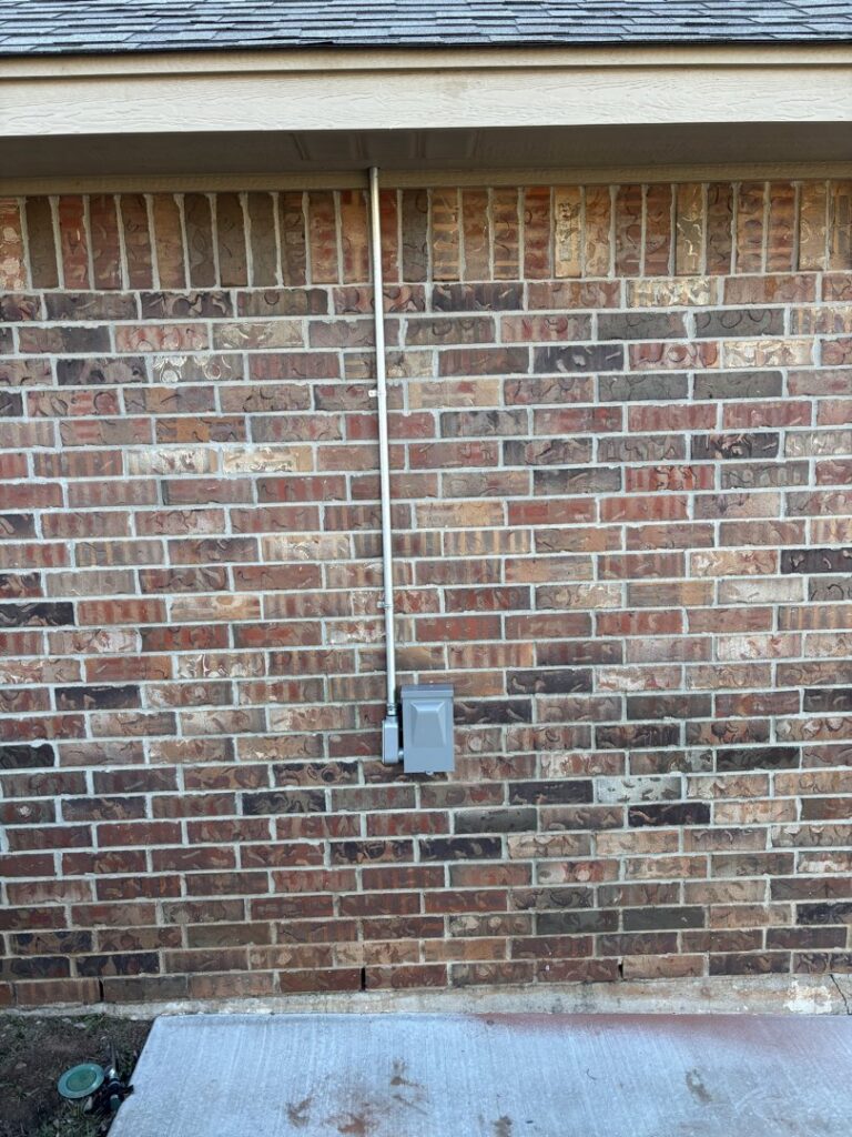 An electrician from Top notch electric llc working on an open electrical panel in Clearwater, FL.