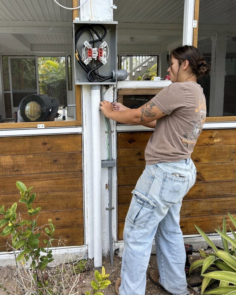 An electrician working on an outdoor electrical meter box for Sound Electric LLC in Saint James City, FL.