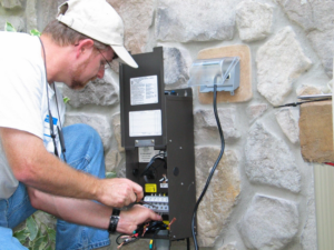 An electrician performing work on an outdoor electrical panel for KC Electric in Pompton Plains, NJ.