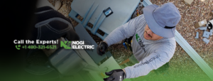 An electrician from Nogi Electric LLC working on an outdoor electrical panel or conduit in Mesa, AZ.