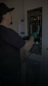 An electrician from Elving Electric working on an electrical panel in Marysville, WA