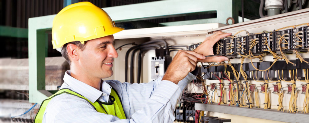 An electrician from Parker Electric working on an industrial electrical panel in Hilliard, OH.