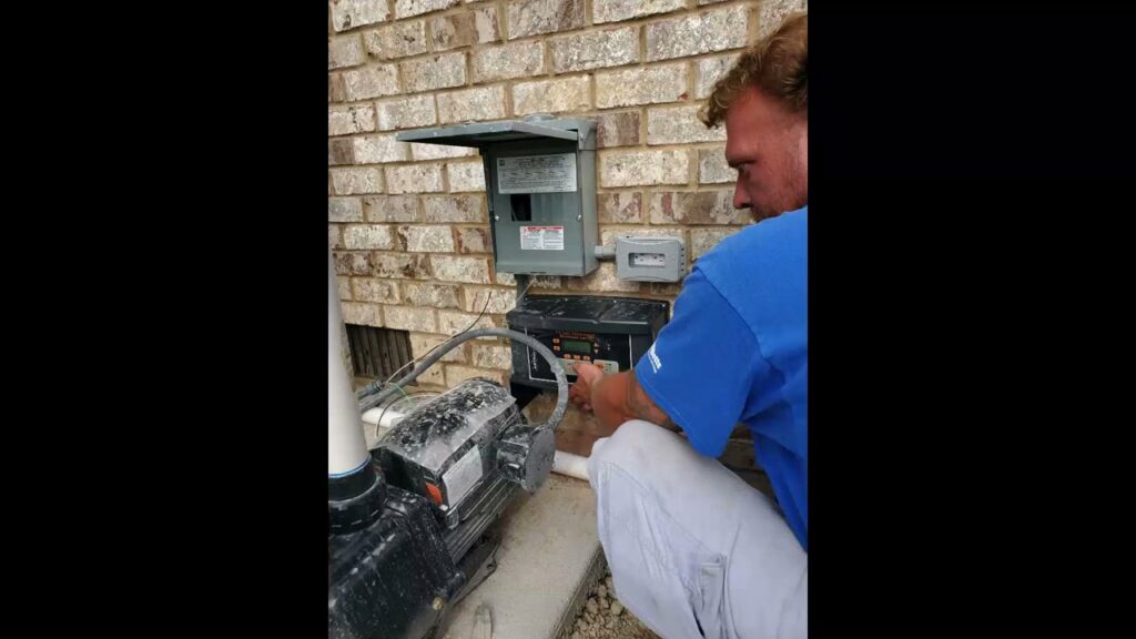 An electrician working on the outdoor electrical wiring for a pool pump at Discount Electrical Service of Franklin in Franklin, TN
