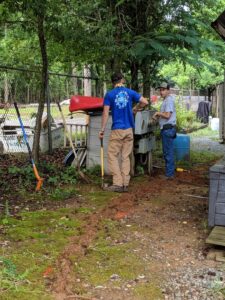 An electrician on a ladder working on the electrical service entrance of a house for Starnes Electric LLC in Rock Hill, SC.