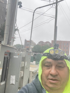 An electrician from Sttrango Electric Company working on outdoor electrical utility boxes in Chicago, IL.