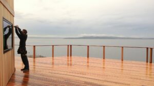 An electrician from Obot Electric working on an outdoor electrical fixture in Bellevue, WA.