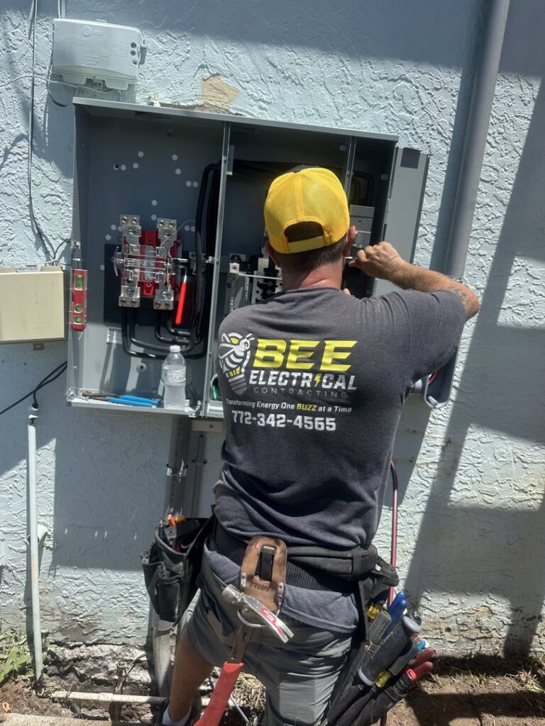 An electrician from Bee Electrical Contracting working on an outdoor electrical panel in Port Saint Lucie, FL.