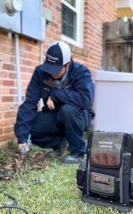 An electrician from Mr. Electric of Montgomery County Alabama working on an outdoor electrical unit in Montgomery, AL.