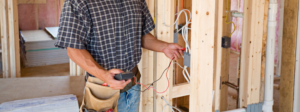 An electrician using a multimeter to test wiring during a job for North Florida Electrical Services in Jacksonville, FL.