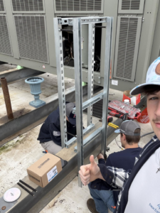 Electricians from Stroh Electrical installing electrical conduit and framing on a commercial rooftop in Montgomery, AL.