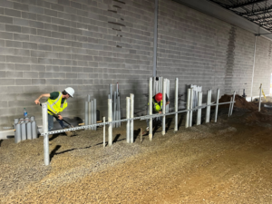 Electricians installing electrical conduits at a construction site for Rebco Electric in Lebanon, OH.