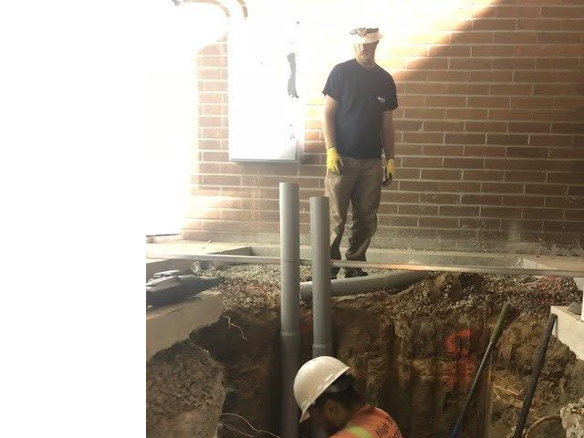 Electricians from High Tech Electric inc. installing electrical conduits in a trench at a job site in Van Nuys, CA.