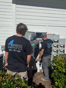 Electricians from Weiss Electric LLC installing outdoor electrical meters for a building in Saint Charles, MO.