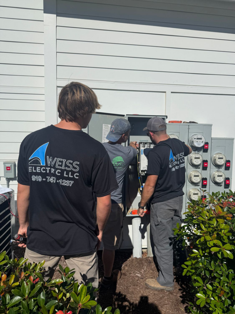 Electricians from Weiss Electric LLC installing outdoor electrical meters for a building in Saint Charles, MO.