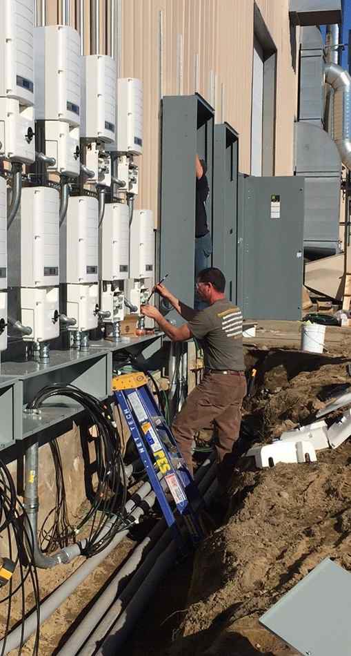 Electricians from Progressive Electrical Services, Inc. installing outdoor wiring and equipment in Lee, NH.