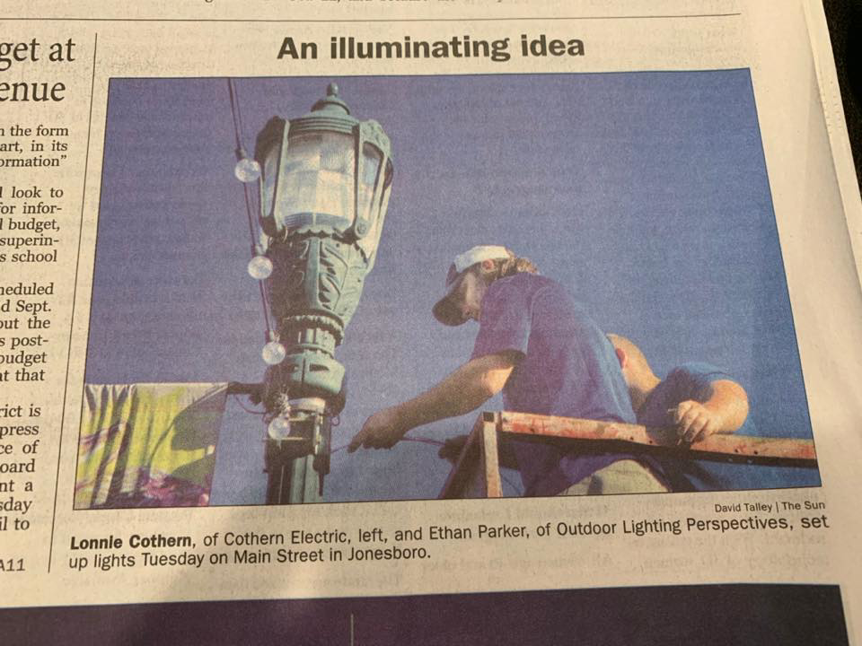 Electricians from Cothern Electric, LLC installing street lights on Main Street in Jonesboro, AR.