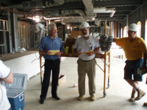 Electricians inspecting a commercial construction site with exposed electrical conduits for MEC, Inc. in Hagerstown, MD