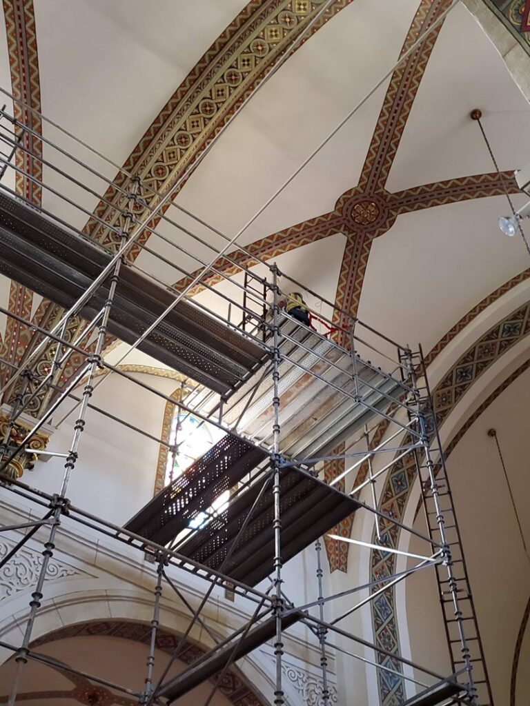 Electricians from Allied Electric on scaffolding working on high ceiling wiring in Sparks, NV.