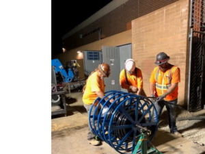 High Tech Electric inc. electricians pulling large electrical cables from a spool during an installation project in Van Nuys, CA.